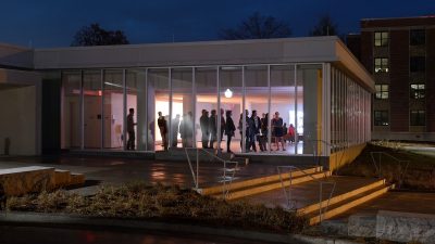  The Moss Art Center's Miles C. Horton Jr. Gallery is seen from the exterior during the center's opening week. Patrons view works by LED artist Leo Villareal, and the gallery is awash in soft pink light from the works.